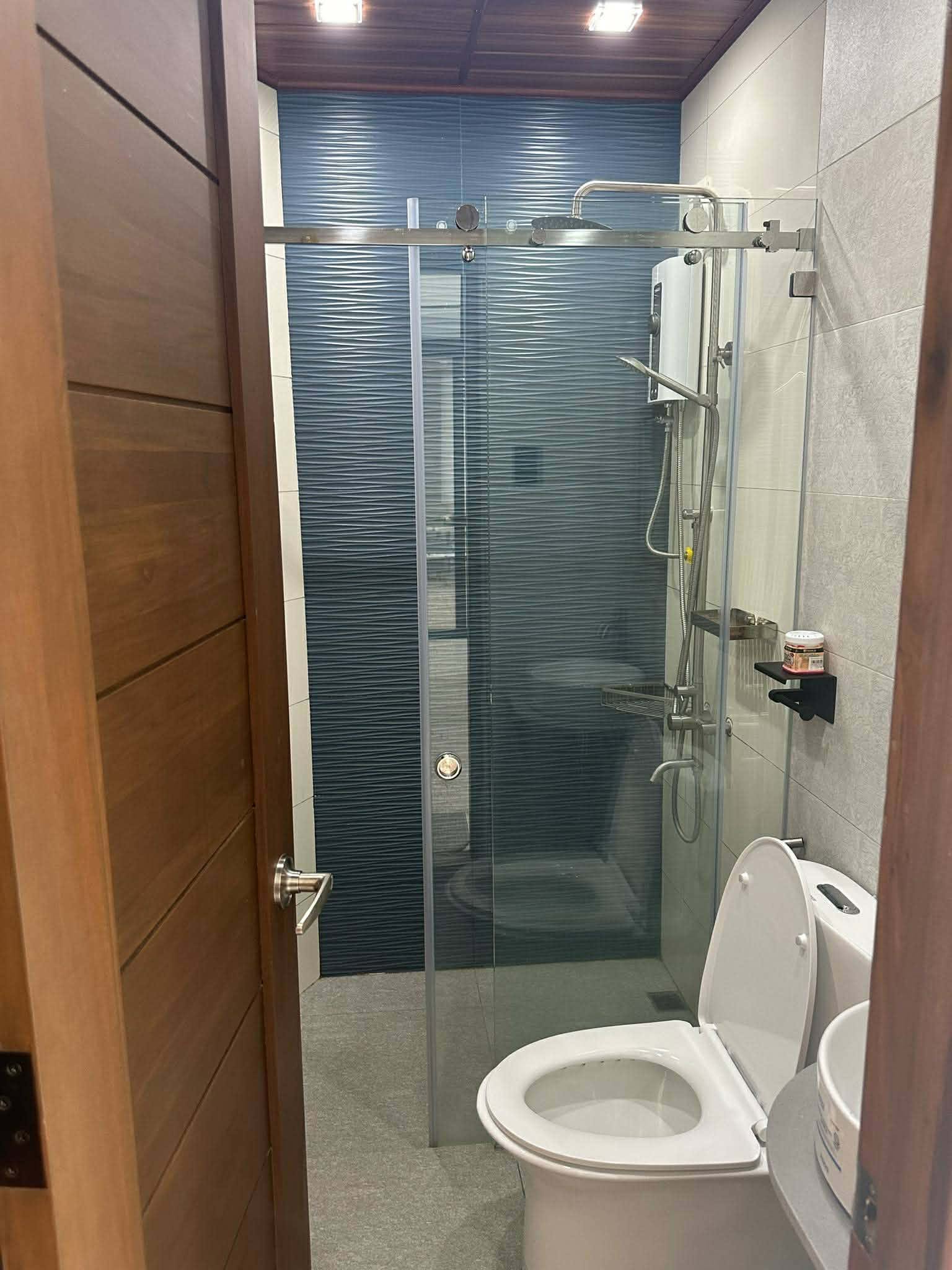 Clean bathroom with glass shower enclosure